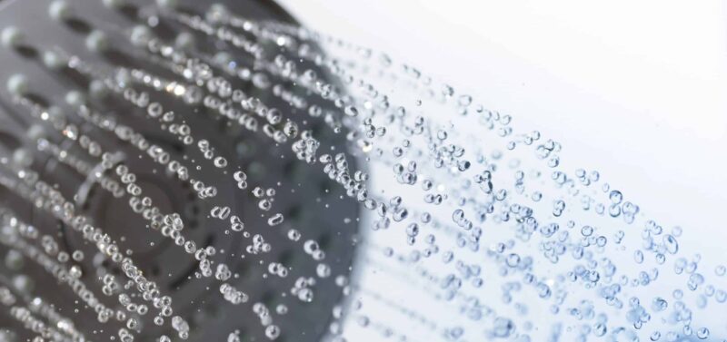 water with low shower pressure spraying down from a showerhead