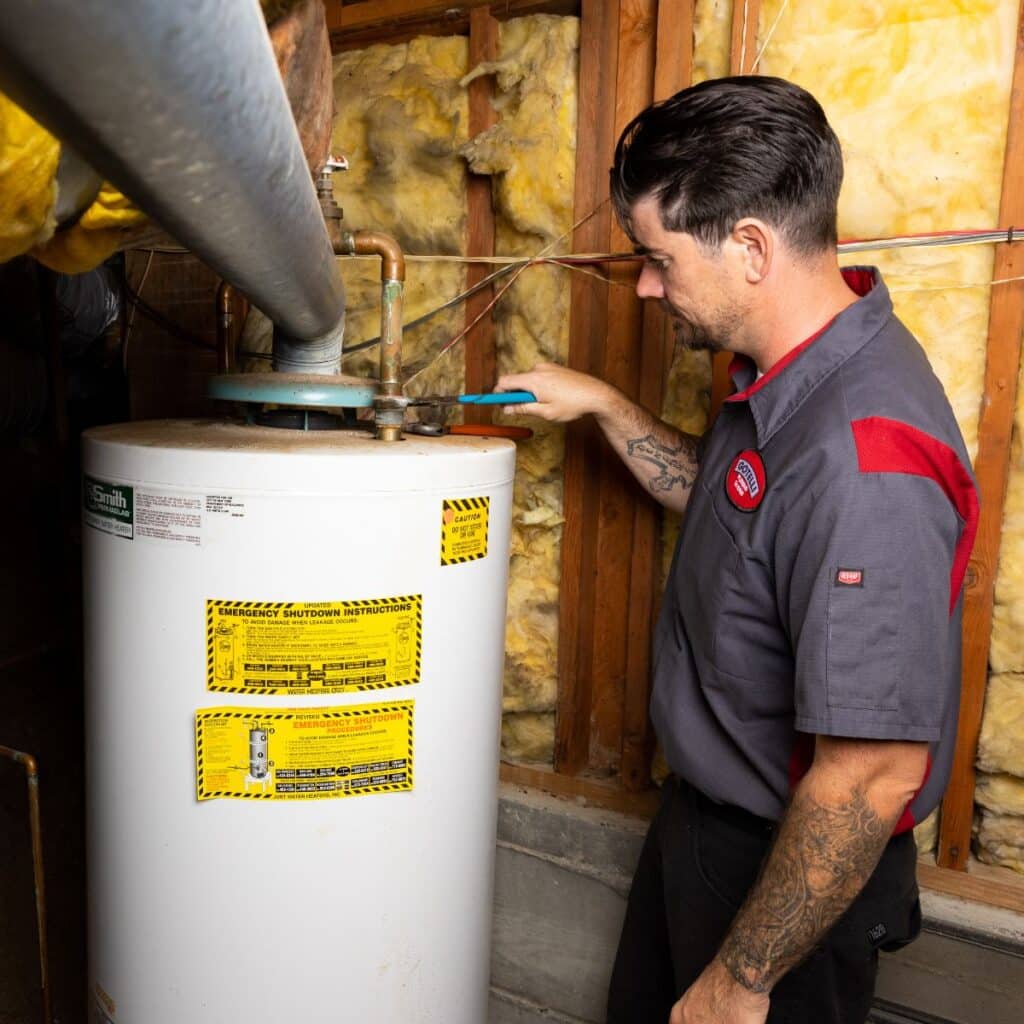 a Gotelli plumber using a wrench to provide San Rafael water heater services