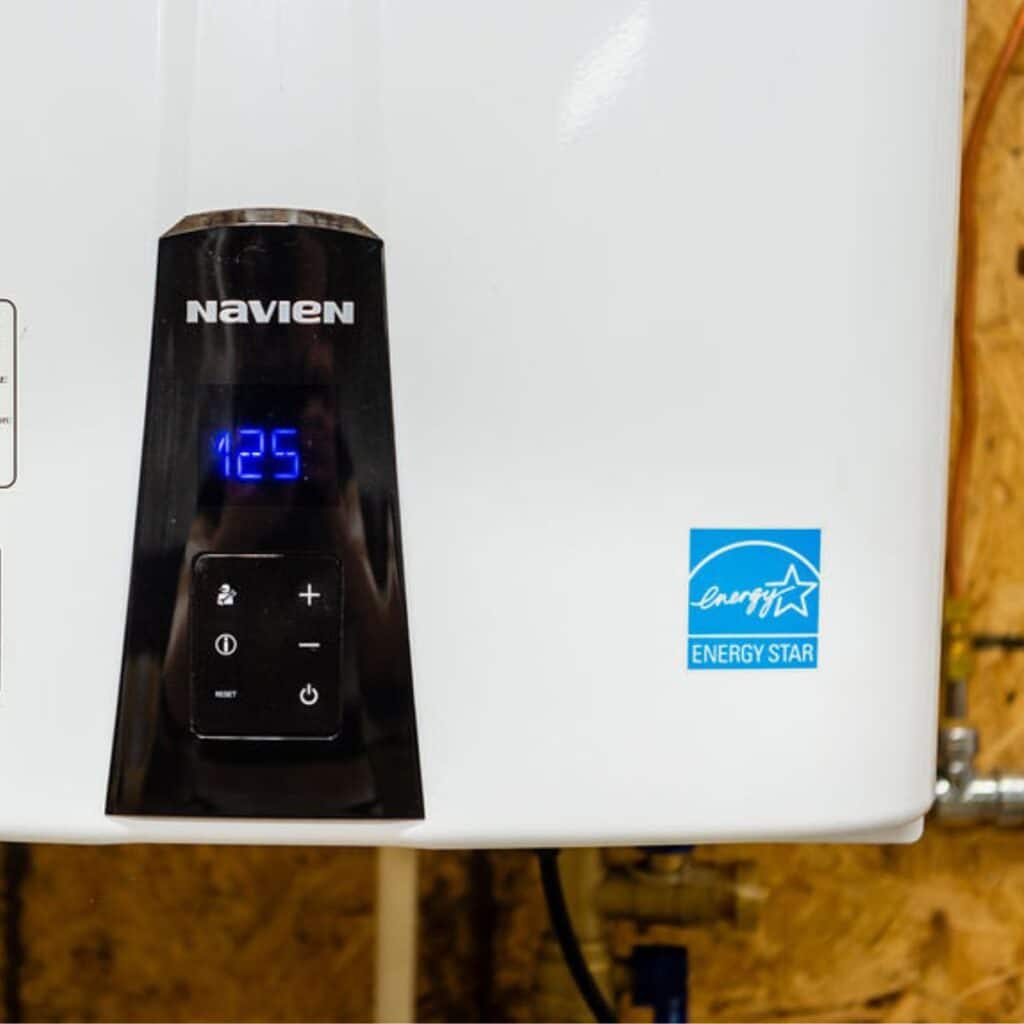 a tankless water heater system installed on the side of a wall