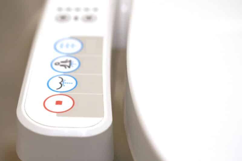 buttons to control settings on the side of a bidet toilet