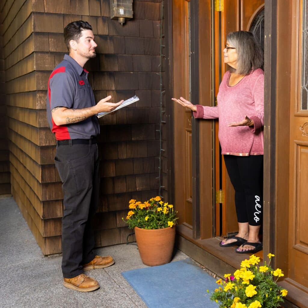 a Gotelli plumber at the entryway of a San Rafael home talking to a customer