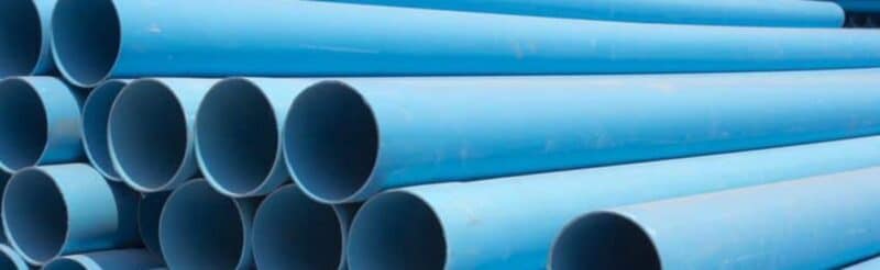 a pile of blue pipes stacked on one another