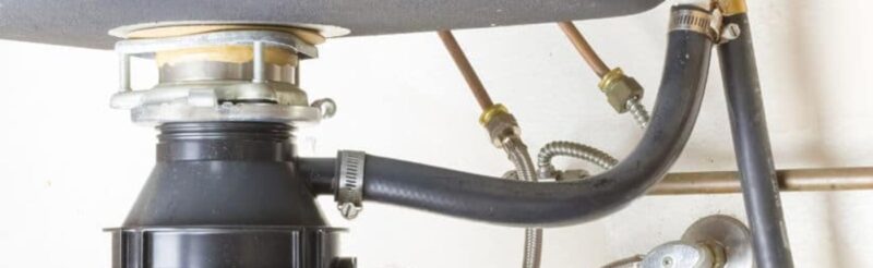a garbage disposal system located underneath a kitchen sink